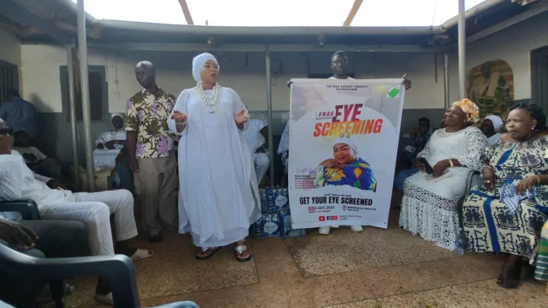 Community members gathered beside the Free Eye Screening event banner